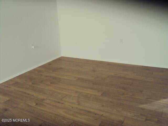 spare room with dark wood-type flooring