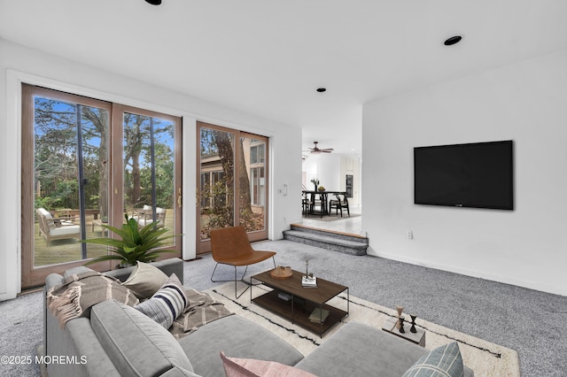 carpeted living room featuring ceiling fan