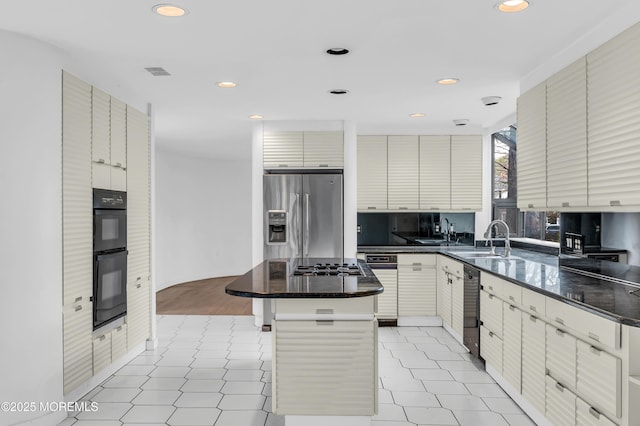 kitchen featuring a kitchen island, sink, and appliances with stainless steel finishes