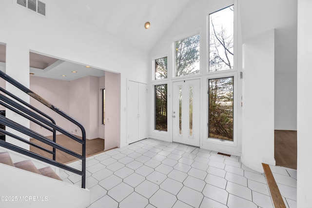 foyer entrance featuring high vaulted ceiling