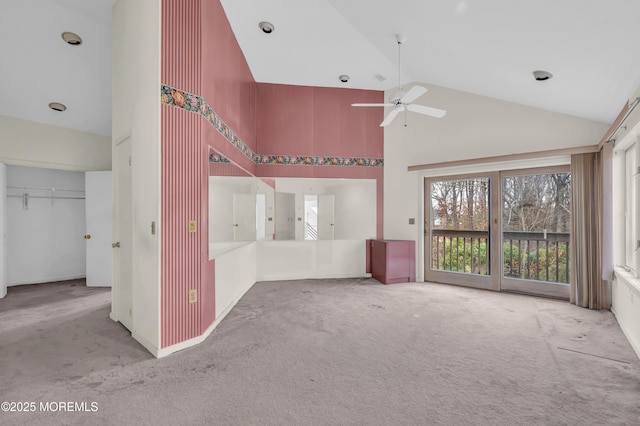 interior space with carpet floors, ceiling fan, and high vaulted ceiling