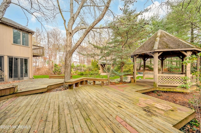 wooden terrace featuring a gazebo