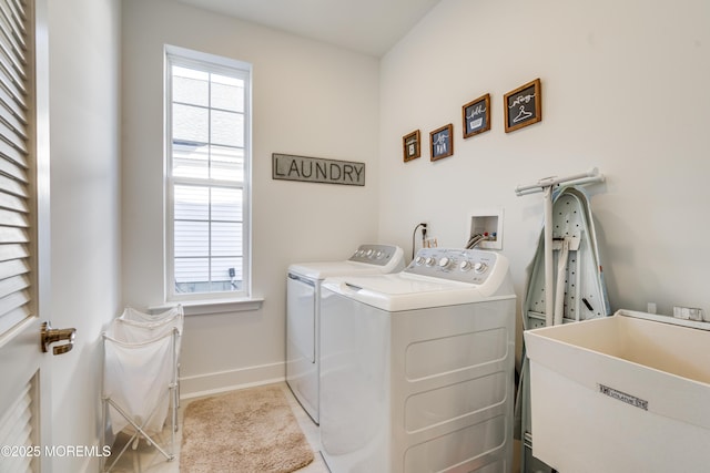 laundry area with washing machine and dryer and sink