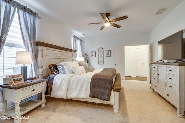 bedroom featuring ceiling fan and light colored carpet