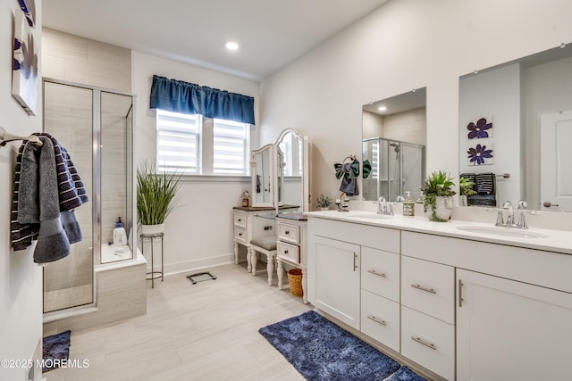 bathroom featuring vanity and a shower with door