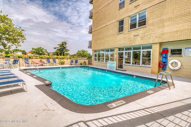 view of swimming pool featuring a patio