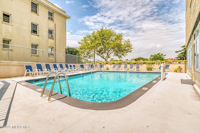 view of swimming pool with a patio area