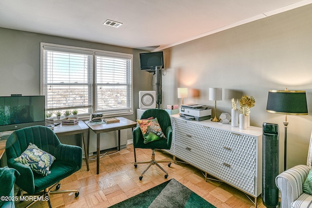 sitting room with light parquet floors and ornamental molding