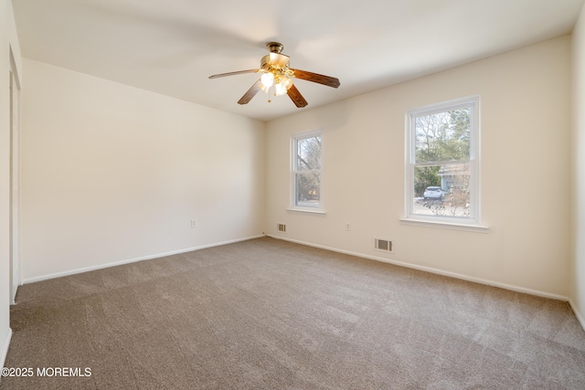 unfurnished room featuring ceiling fan and carpet floors