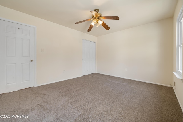 carpeted empty room with ceiling fan