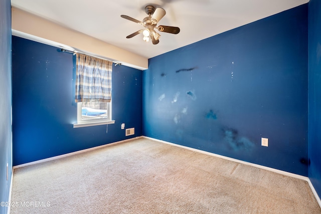 empty room featuring carpet floors and ceiling fan