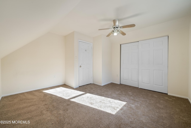 unfurnished bedroom with ceiling fan, vaulted ceiling, and carpet floors