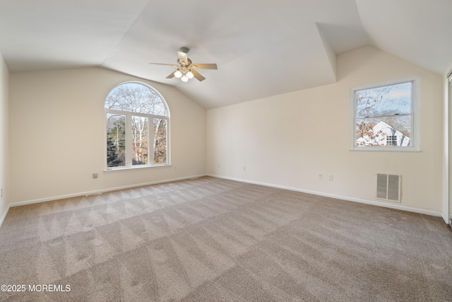 carpeted spare room with ceiling fan and vaulted ceiling