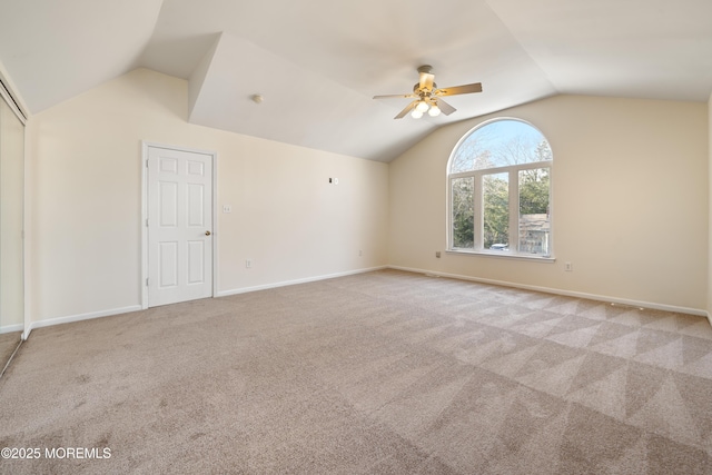 carpeted spare room with lofted ceiling and ceiling fan