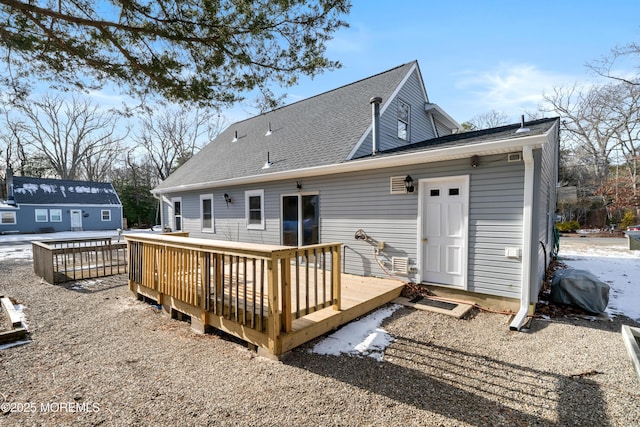 rear view of property featuring a deck