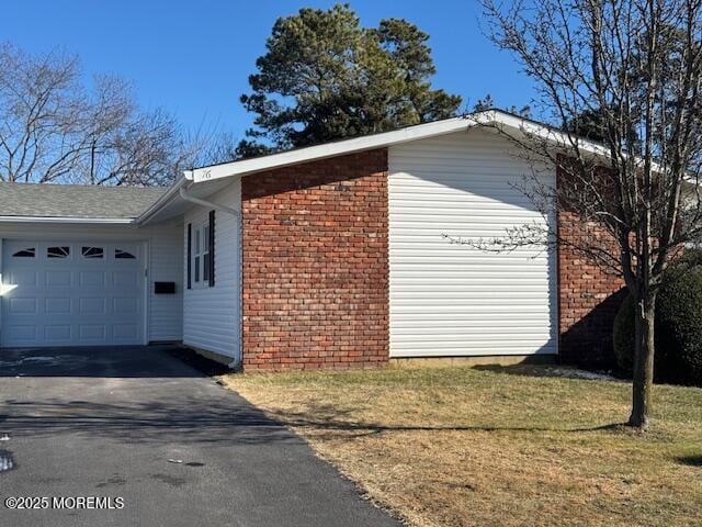 view of property exterior featuring a yard and a garage