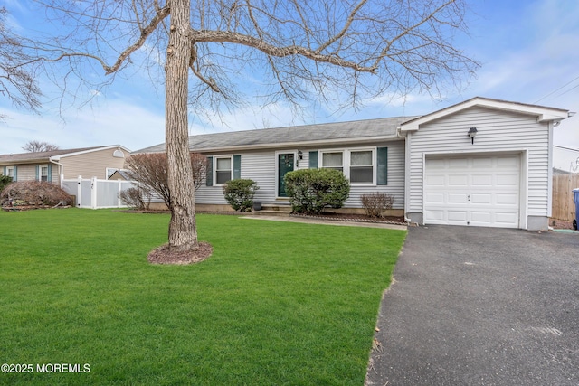 ranch-style home with a front lawn and a garage