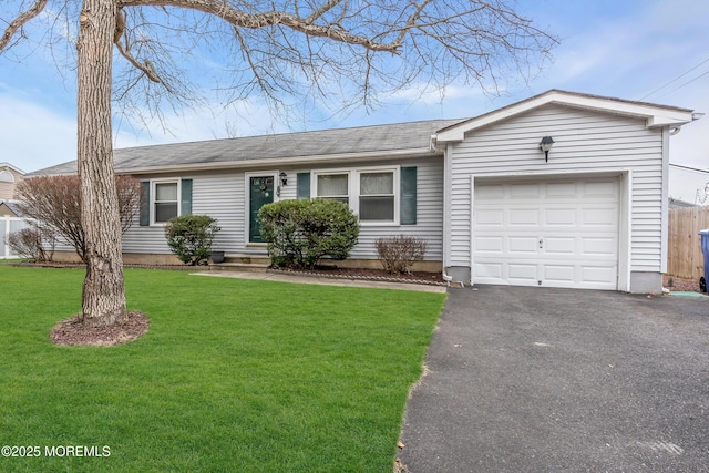 ranch-style home featuring a garage and a front lawn