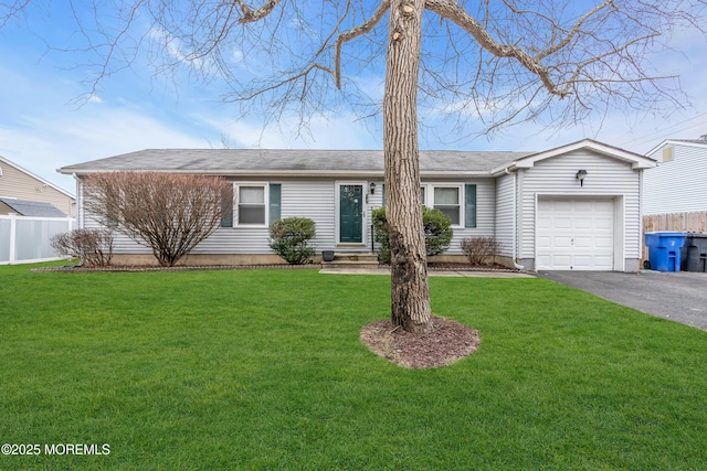 ranch-style home featuring a garage and a front lawn