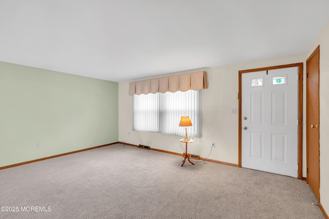 view of carpeted entrance foyer