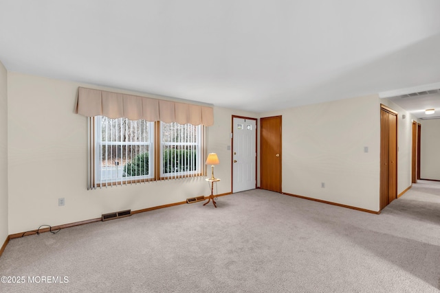 spare room featuring light colored carpet