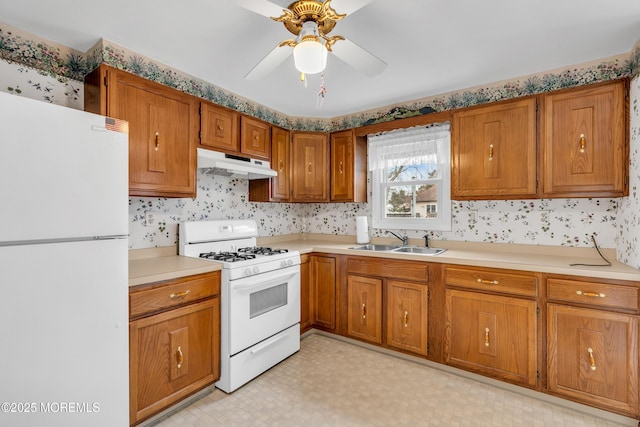 kitchen featuring ceiling fan, sink, and white appliances