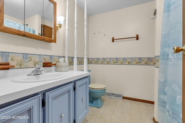 bathroom featuring vanity and toilet