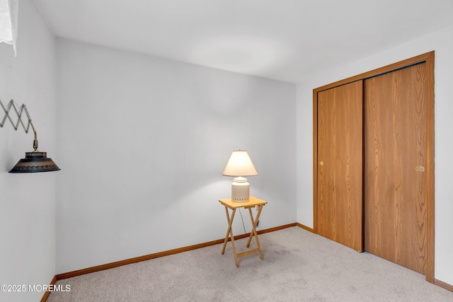 unfurnished bedroom with light colored carpet and a closet