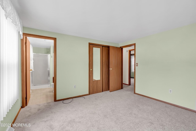 unfurnished bedroom with light carpet and a closet