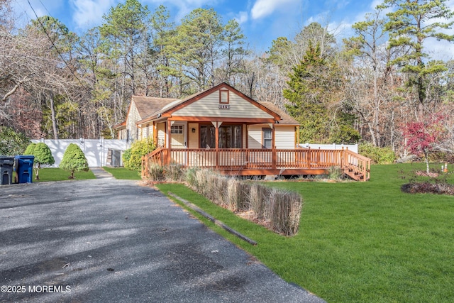 bungalow-style home with a front lawn