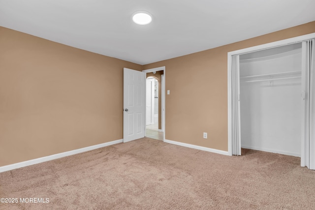 unfurnished bedroom featuring carpet floors and a closet