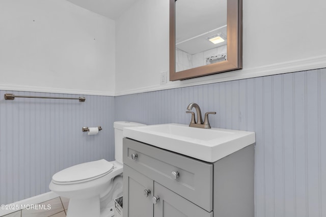 bathroom with tile patterned floors, vanity, and toilet