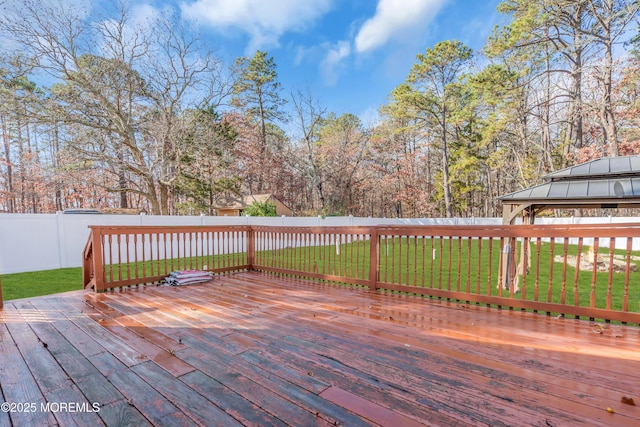 deck featuring a gazebo and a yard