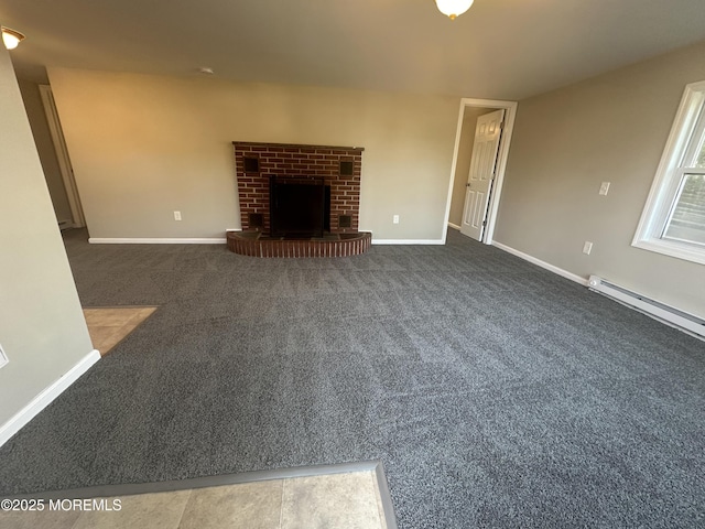 unfurnished living room with a fireplace, a baseboard radiator, and dark colored carpet