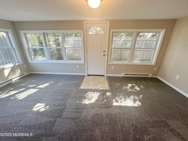 carpeted entryway with a baseboard heating unit