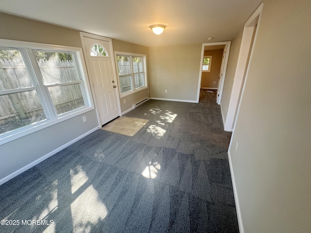 interior space with a healthy amount of sunlight and a baseboard heating unit