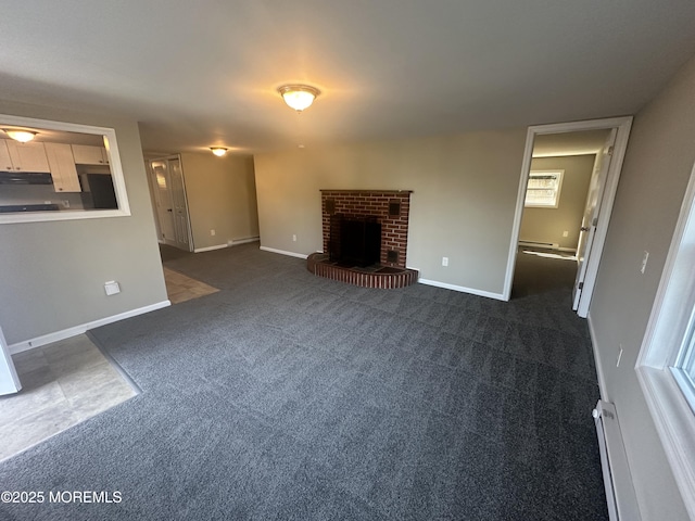 unfurnished living room featuring a fireplace, dark carpet, and baseboard heating