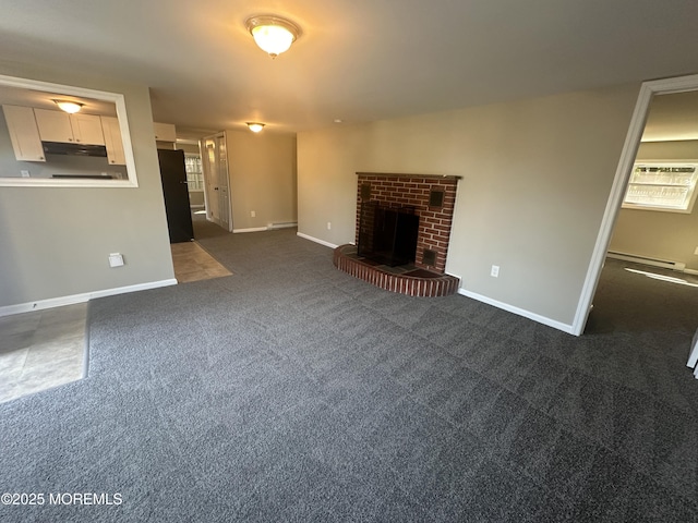 unfurnished living room featuring a fireplace, a wall mounted AC, dark carpet, and baseboard heating