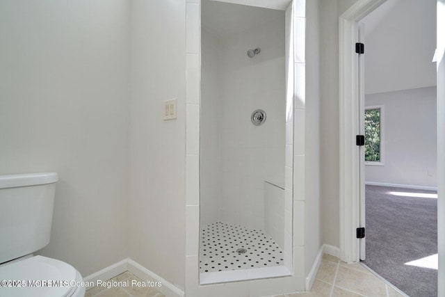 bathroom with toilet, tile patterned flooring, and walk in shower