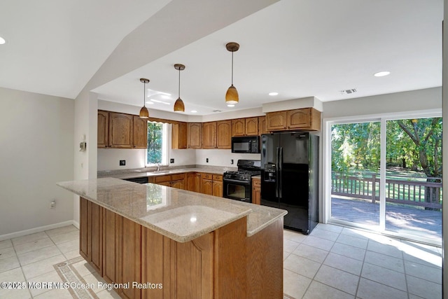 kitchen with black appliances, light stone counters, light tile patterned floors, and sink