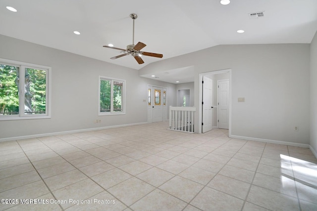 tiled spare room featuring ceiling fan and vaulted ceiling