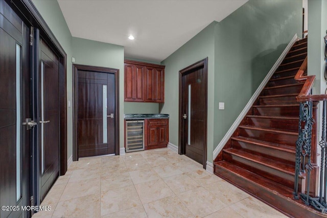 kitchen with wine cooler and light tile patterned floors