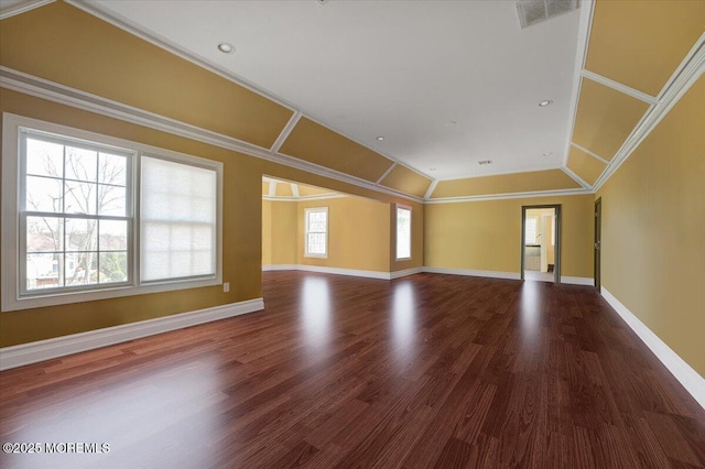 unfurnished room featuring hardwood / wood-style floors, crown molding, and lofted ceiling