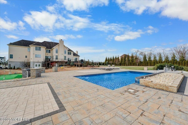 view of swimming pool featuring a patio area