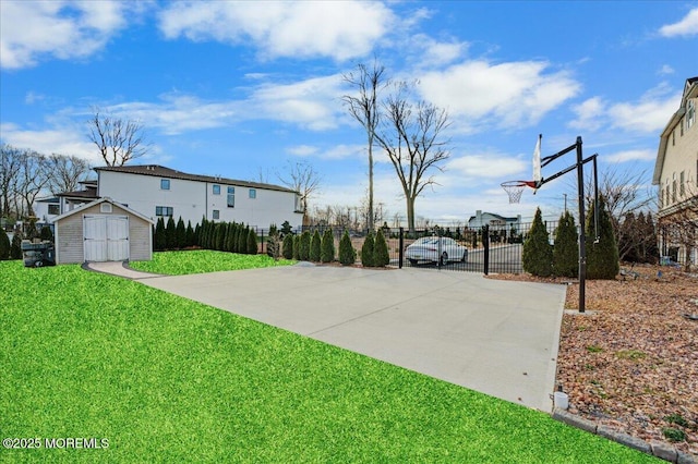 view of sport court with a lawn