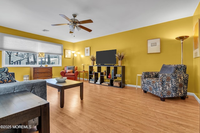 living room featuring hardwood / wood-style flooring and ceiling fan