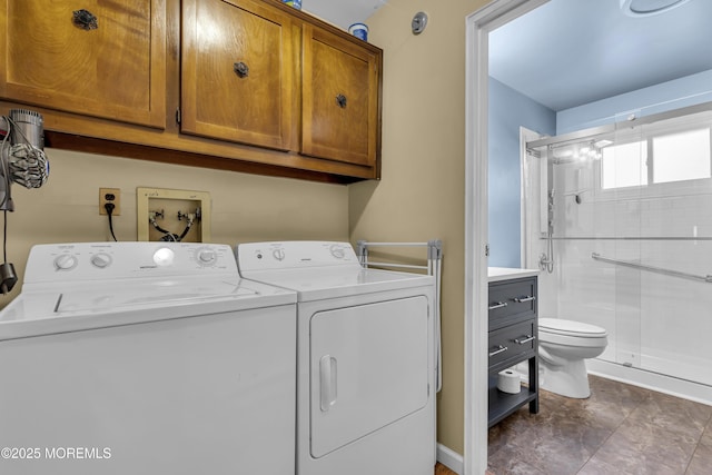 clothes washing area with cabinets and separate washer and dryer