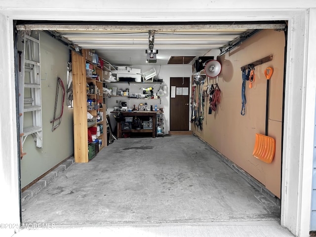 garage with a workshop area and a garage door opener