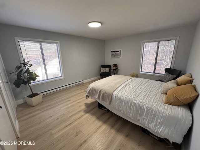 bedroom featuring light hardwood / wood-style floors and a baseboard radiator