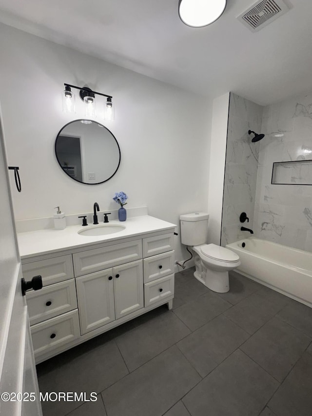 full bathroom with toilet, tile patterned floors, tiled shower / bath, and vanity